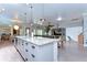 Spacious kitchen boasts a large island with granite countertops and modern cabinetry at 6120 Watercolor Dr, Lithia, FL 33547