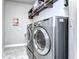 Bright laundry room, features modern washer and dryer, and ample shelving at 6120 Watercolor Dr, Lithia, FL 33547