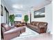 Living room featuring leather sofas and hardwood floors at 6120 Watercolor Dr, Lithia, FL 33547