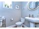 Elegant powder room with pedestal sink and frameless mirror at 6120 Watercolor Dr, Lithia, FL 33547