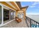 Private balcony overlooking the water with wicker seating at 6408 Bright Bay Ct, Apollo Beach, FL 33572