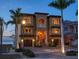 Luxury waterfront home with fountain and palm trees at dusk at 6408 Bright Bay Ct, Apollo Beach, FL 33572