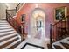 Grand foyer with sweeping staircase, ornate railings, and art at 6408 Bright Bay Ct, Apollo Beach, FL 33572