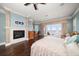 Main bedroom with water views, fireplace, and hardwood floors at 6408 Bright Bay Ct, Apollo Beach, FL 33572