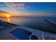 Elevated view of infinity pool and hot tub with sunset view at 6408 Bright Bay Ct, Apollo Beach, FL 33572