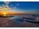 Stunning infinity pool and hot tub overlooking the water at sunset at 6408 Bright Bay Ct, Apollo Beach, FL 33572