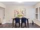 Bright dining room with wooden table and blue chairs, features hardwood floors and an accent wall at 674 61St S Ave, St Petersburg, FL 33705