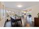 Open concept dining area with hardwood floors, a wooden table, and blue chairs. Kitchen view at 674 61St S Ave, St Petersburg, FL 33705