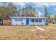 Charming light blue house with a well-maintained lawn and walkway at 674 61St S Ave, St Petersburg, FL 33705