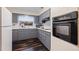 Gray kitchen with updated appliances and white backsplash at 674 61St S Ave, St Petersburg, FL 33705