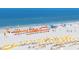 Aerial view of beach with many umbrellas and people enjoying the sun at 690 Island Way # 410, Clearwater Beach, FL 33767