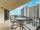 Private balcony with table and chairs offering partial ocean view at 690 Island Way # 410, Clearwater Beach, FL 33767