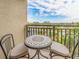 Relaxing balcony with table and chairs, offering scenic views at 690 Island Way # 410, Clearwater Beach, FL 33767