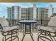 Relaxing balcony with two chairs and a table, overlooking city views at 690 Island Way # 410, Clearwater Beach, FL 33767