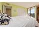 Bright bedroom with balcony access and white bedding at 690 Island Way # 410, Clearwater Beach, FL 33767