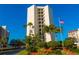 Island Walk building exterior with palm trees at 690 Island Way # 410, Clearwater Beach, FL 33767