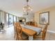 Bright dining room with a wood table and chandelier at 690 Island Way # 410, Clearwater Beach, FL 33767