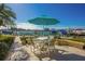 Waterfront patio with table and chairs, perfect for dining al fresco at 690 Island Way # 410, Clearwater Beach, FL 33767