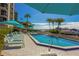 Relaxing pool area with patio furniture and waterfront views at 690 Island Way # 410, Clearwater Beach, FL 33767