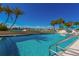 Inviting community pool with waterfront views and lounge chairs at 690 Island Way # 410, Clearwater Beach, FL 33767