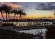 Evening view of a community pool with sunset over the water at 690 Island Way # 410, Clearwater Beach, FL 33767