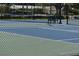 Community tennis court with chain-link fence at 690 Island Way # 410, Clearwater Beach, FL 33767