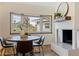 Cozy dining area with a round table and bay window, adjacent to a fireplace at 7000 Dr Martin Luther King Jr S St, St Petersburg, FL 33705