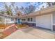 Brick walkway leading to a gray house with a white garage door at 7000 Dr Martin Luther King Jr S St, St Petersburg, FL 33705