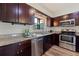 Updated kitchen featuring stainless steel appliances and dark wood cabinets at 7000 Dr Martin Luther King Jr S St, St Petersburg, FL 33705