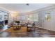 Living room with hardwood floors, beige couch, and a view into dining area at 7000 Dr Martin Luther King Jr S St, St Petersburg, FL 33705