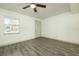 Grey vinyl flooring, neutral walls, and a ceiling fan at 7117 E Bank Dr # 2, Tampa, FL 33617