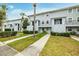 Exterior view of a light gray building with parking and landscaping at 7117 E Bank Dr # 2, Tampa, FL 33617