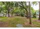 Peaceful pond surrounded by mature trees and lush grass at 7117 E Bank Dr # 2, Tampa, FL 33617