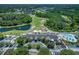 Aerial view of community clubhouse, pool, and golf course at 7304 Cleopatra Dr, Land O Lakes, FL 34637