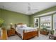 Cozy bedroom with wood bed frame and bay window with shutters at 7304 Cleopatra Dr, Land O Lakes, FL 34637