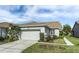 Single-story house with attached garage and well-maintained landscaping at 7304 Cleopatra Dr, Land O Lakes, FL 34637