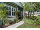 Inviting front entrance with lush landscaping and a screened door at 7304 Cleopatra Dr, Land O Lakes, FL 34637