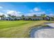 Clubhouse and green with sand trap and palm trees at 7304 Cleopatra Dr, Land O Lakes, FL 34637