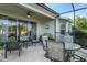 Relaxing screened patio with seating area and glass doors at 7304 Cleopatra Dr, Land O Lakes, FL 34637