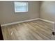 Spacious bedroom with light wood laminate flooring at 7400 Spring Hill Dr # 209, Spring Hill, FL 34606