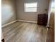 Bright bedroom with wood laminate flooring and dresser at 7400 Spring Hill Dr # 209, Spring Hill, FL 34606