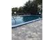 Community swimming pool with a tiled deck at 7400 Spring Hill Dr # 209, Spring Hill, FL 34606