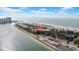 Aerial view highlighting condo building's location near beach and tennis courts at 7537 Bayshore Dr # 406, Treasure Island, FL 33706