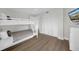 Bedroom with bunk beds, dresser and balcony access at 7537 Bayshore Dr # 406, Treasure Island, FL 33706