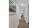 Light and airy hallway with wood-look flooring, leading to bedroom at 7537 Bayshore Dr # 406, Treasure Island, FL 33706