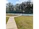 Well-maintained tennis court with surrounding trees and walkway at 8702 Mallard Reserve Dr # 104, Tampa, FL 33614