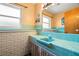 Retro bathroom with light teal tile and a single sink vanity at 1085 Indian Rocks S Rd, Largo, FL 33770