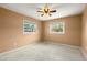 Simple bedroom with light walls, ceiling fan, and carpet at 1085 Indian Rocks S Rd, Largo, FL 33770