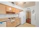 Kitchen with white appliances and wood cabinets at 1085 Indian Rocks S Rd, Largo, FL 33770