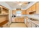 Kitchen with light wood cabinets and appliances at 1085 Indian Rocks S Rd, Largo, FL 33770